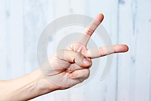 Woman hand scissors gesture, peace gesture