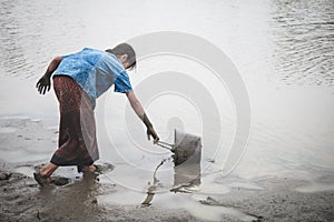 Woman hand are scooping water on cracked ground.