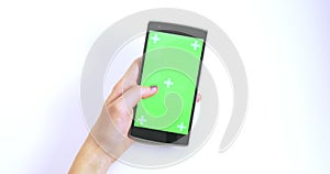 Woman Hand Scrolling On Green Screen Smart Phone With Trackers On White Background