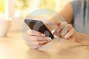 Woman hand selecting content on a smart phone photo