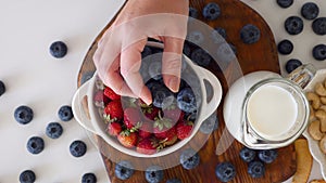 Woman Hand Serving Healthy Morning Breakfast Blueberries, Strawberries Bowl