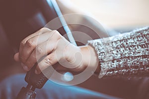 Woman hand shifting the gear stick while driving a car