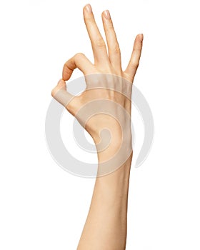 Woman hand show sign ok or okey. Beautiful elegant female hand show gesture finger fine on isolated white