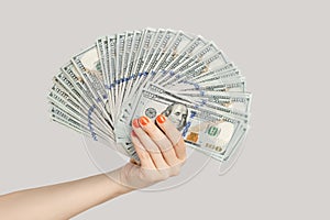 Woman hand showing big fan of dollar banknotes, salary, earning, money.