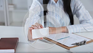 Woman Hand showing a blank business card