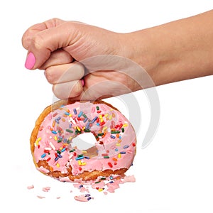 Woman Hand Smashing Donut with Sprinkles isolated