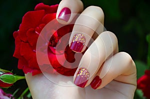 Woman hand with sparkle pink manicure