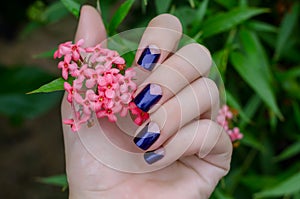 Woman hand with sparkle purple nail design