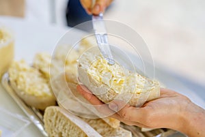 woman hand spreads bread with cheese salad with garlic. the process of preparing a snack for a grill party