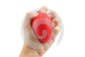 Woman hand squeezing a stress ball on white background