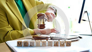 Woman hand striking with judge gavel in court room