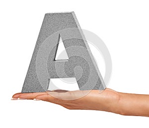 Woman hand, studio and alphabet or capital letter A for learning, advertising or font. A person show sign, character or