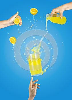 Woman hand support fly glass of tasty cocktail with lemon and ice with splash, ingredients falling to glassful. Women hands is