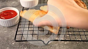 Woman hand takes Mexican fried meat pies empanadas cheburek with the baking rack