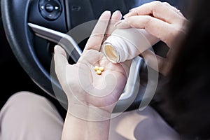 woman hand taking Antihistamines or allergy medicine before driving could affect Sleepiness and Risk of Accidents