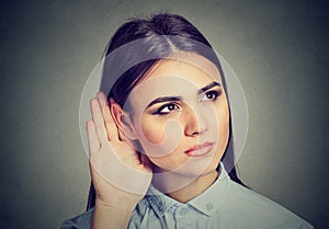 Woman with hand to ear gesture listening carefully