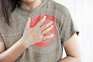 Woman hand touching her chest  having heart attack