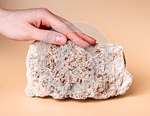 Woman hand touching stone. Sensation from stroking tough material. Thigmesthesia, taction. World navigation concept