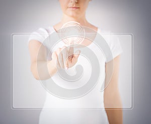 Woman hand touching virtual screen