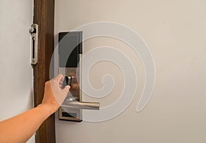 Woman hand twist door lock in hotel for safety