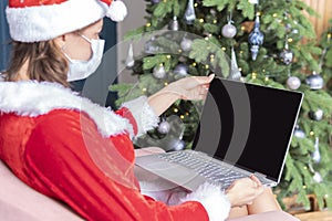Woman hand typing computer keyboard on desk office concept office christmas and happy new year. A young woman in Santa