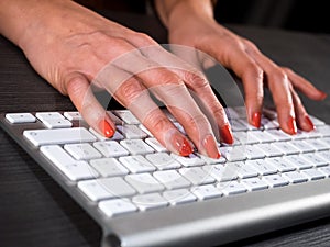 Woman hand typing on keyboard