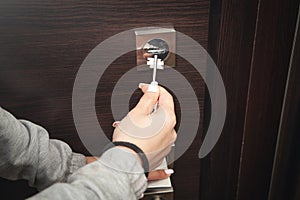 Woman hand unlocking door with key