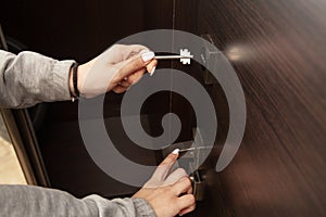 Woman hand unlocking door with key