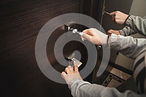 Woman hand unlocking door with key