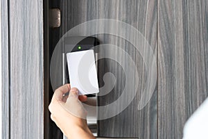 Woman hand using electronic smart key card to unlock door in hotel or house. Digital lock, door access control, contactless