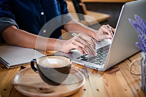 Woman hand using laptop computer