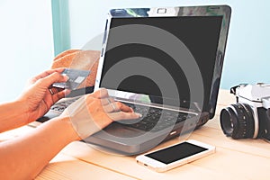 Woman hand using laptop and credit card for booking hotel or reservation airline, Business or Travel concept. Black screen