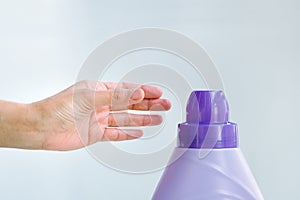 Woman hand using liquid laundry softener detergent washing cloth