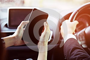 Woman hand is using mobile smart phone empty blank screen in car. idea open map gps