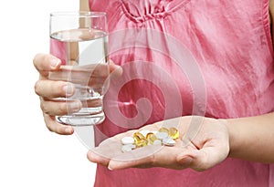 Woman hand with vitamins and supplements