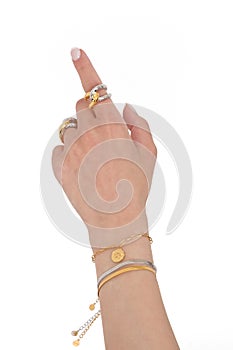 Woman hand wearing Butterfly and Snake Chain bracelets and Interlocked Golden and Silver Rings set against a white background.