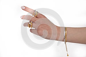 Woman hand wearing Snake Chain bracelets and Interlocked Golden and Silver Rings set against a white background. Beautiful