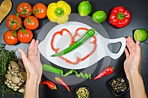 Woman hand and white cutting board framed the vegetables