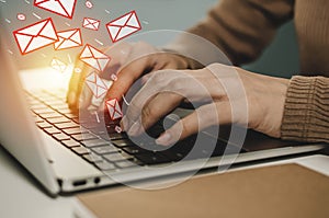 Woman hand working business on laptop computer send email on desk at home office with virtual digital icon, social network, mail,