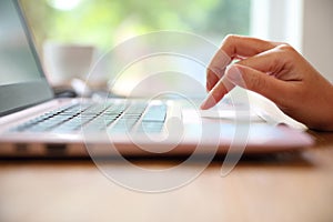 Woman hand working at coffee shop hand on keyboard