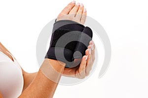 Woman hand with a wrist and finger brace, orthopeadic equipment over white