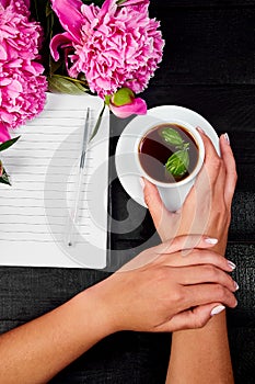 Woman hand writing diary with coffee