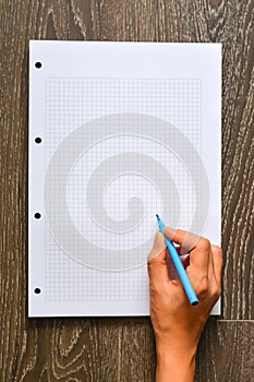 Woman hand writing on empty math book