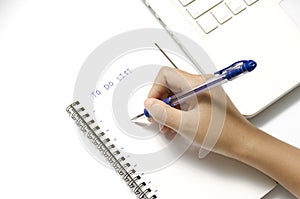 Woman hand writing with pen on notebook