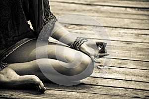 Woman hand in yoga symbolic gesture mudra bw outdoor photo