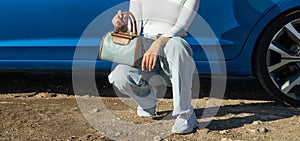 Woman with handbag near the car