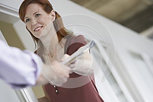 Woman Handing Colleague Document