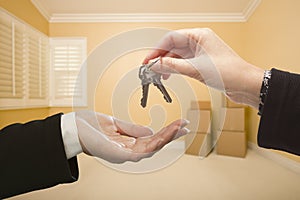 Woman Handing Over the House Keys Inside Empty Room