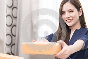 Woman handing package box for mailing and shipment