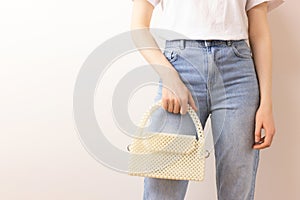 Woman with a handmade bag made from pearl imitation beads.